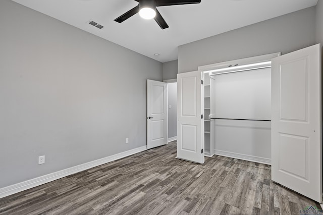 unfurnished bedroom with hardwood / wood-style floors, a closet, and ceiling fan