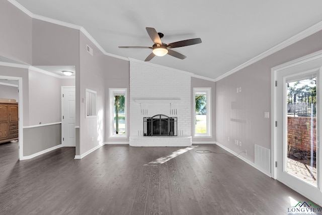 unfurnished living room with vaulted ceiling, ceiling fan, crown molding, a fireplace, and dark hardwood / wood-style floors