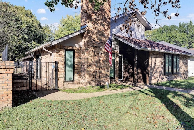 view of side of home featuring a yard