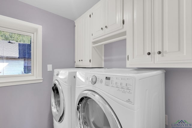 laundry area with cabinets and separate washer and dryer