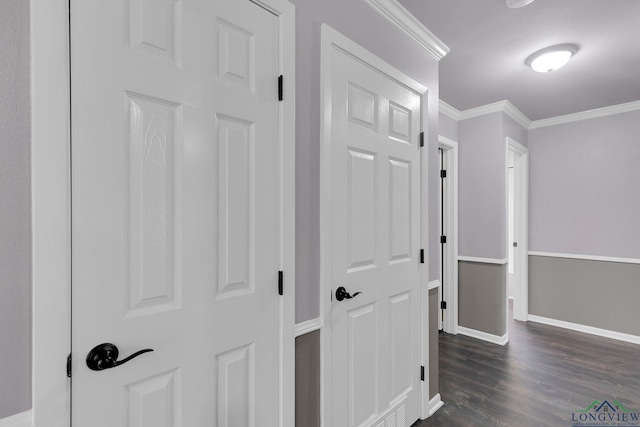 corridor with dark hardwood / wood-style floors and ornamental molding