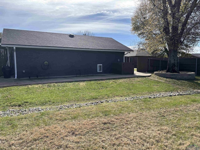 back of property with a yard and a patio