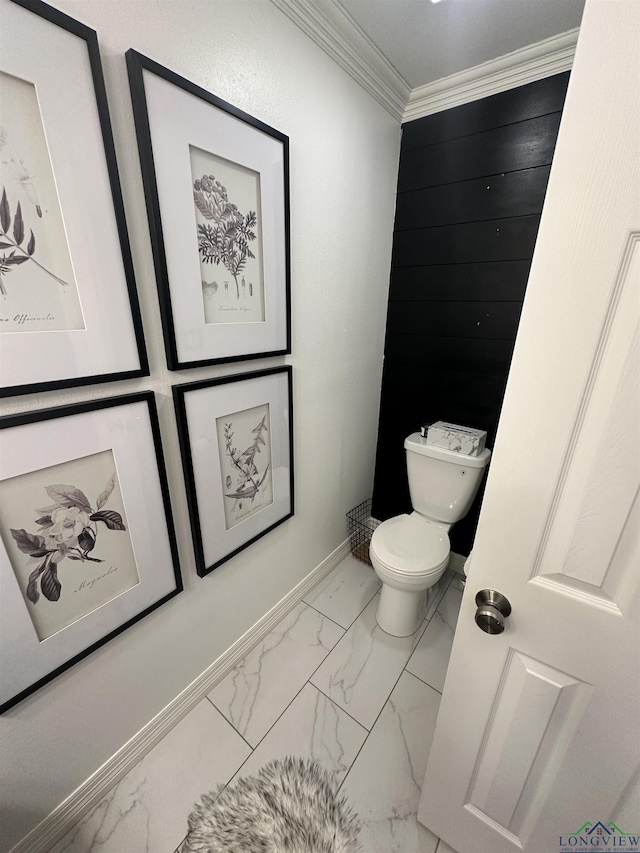 bathroom featuring crown molding and toilet