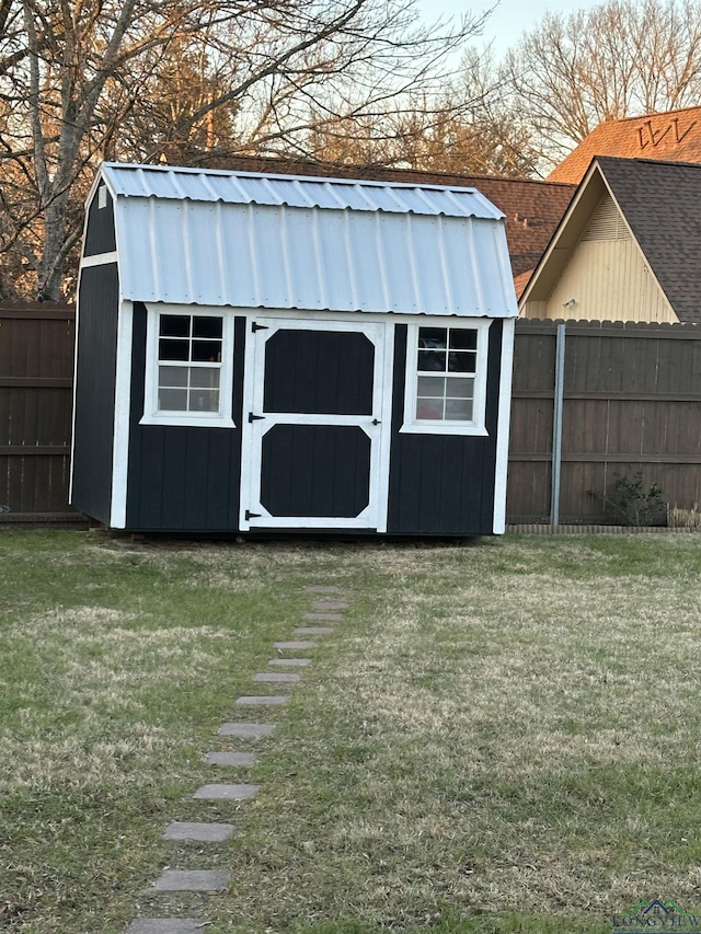 view of outbuilding with a lawn