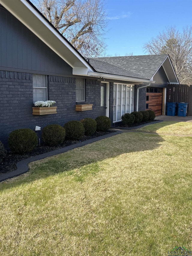 view of front of house with a garage and a front lawn