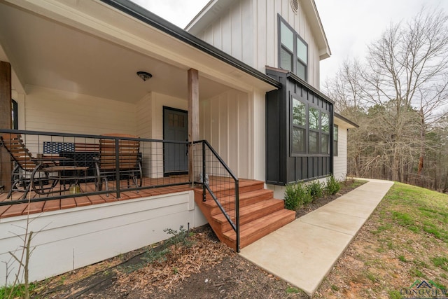 entrance to property with a porch and board and batten siding