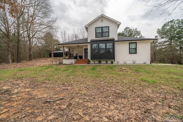 view of front of house featuring board and batten siding, a porch, and a front yard