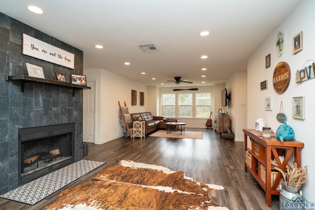 living room featuring recessed lighting, visible vents, wood finished floors, and a tiled fireplace