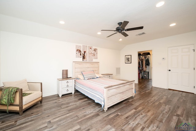 bedroom with recessed lighting, visible vents, a walk in closet, and wood finished floors