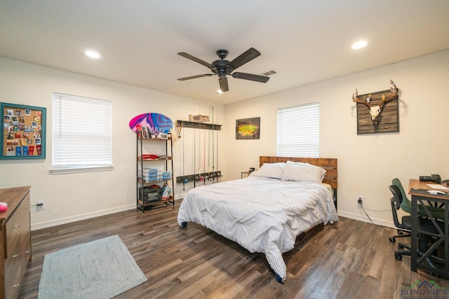 bedroom featuring visible vents, multiple windows, baseboards, and dark wood finished floors