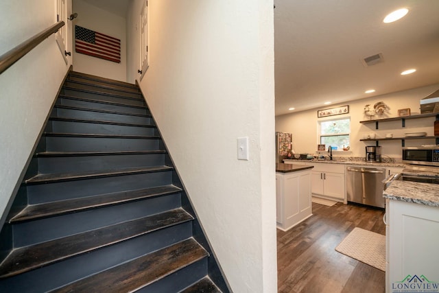 stairs featuring visible vents, recessed lighting, and wood finished floors