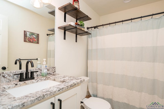 full bathroom featuring visible vents, toilet, and vanity