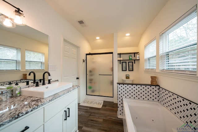 full bath with visible vents, a jetted tub, wood finished floors, a shower stall, and vanity