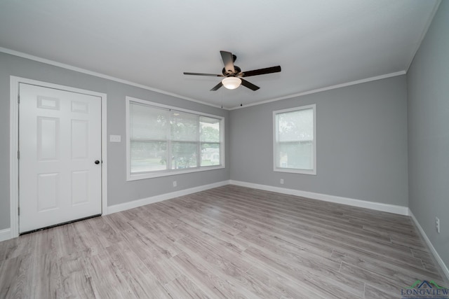 spare room with light wood-type flooring, ceiling fan, and crown molding