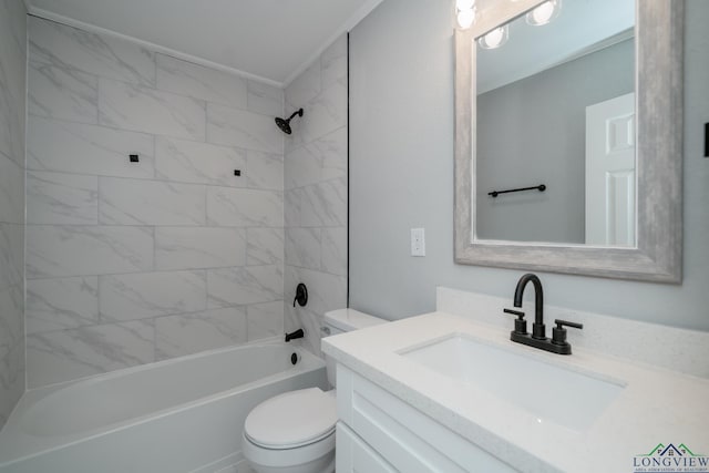 full bathroom featuring tiled shower / bath combo, toilet, and vanity