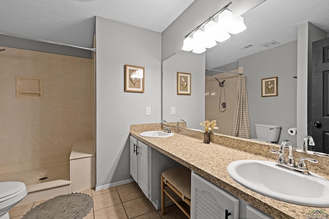 full bath with toilet, tile patterned flooring, a sink, and tiled shower