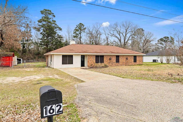 view of front of property with fence, a chimney, and a front lawn