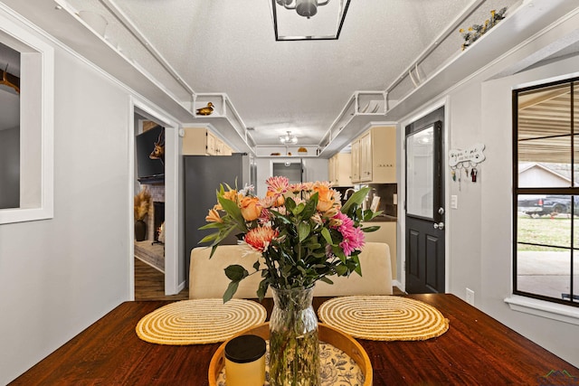 corridor featuring a textured ceiling and wood finished floors