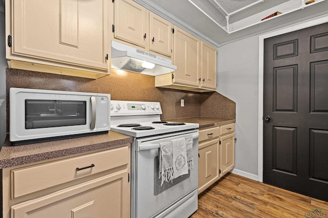 kitchen with a toaster, under cabinet range hood, wood finished floors, dark countertops, and white electric range oven