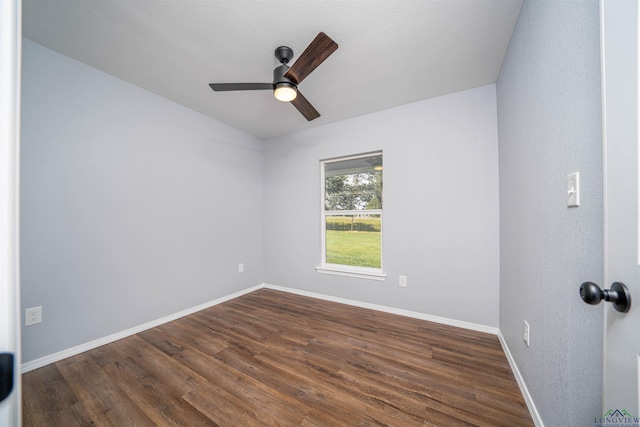 18385 Fm 1716, Tatum, TX 75691 - empty room with a ceiling fan, dark wood-style floors, and baseboards