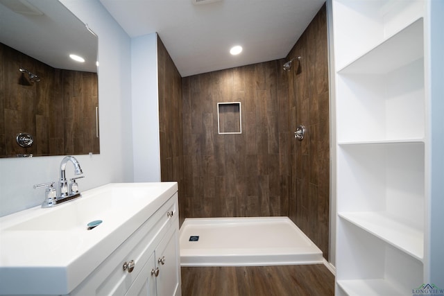 18385 Fm 1716, Tatum, TX 75691 - full bathroom with vanity, tiled shower, wood finished floors, and recessed lighting