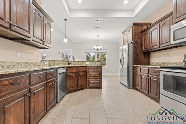 kitchen with a tray ceiling, stainless steel appliances, visible vents, and light tile patterned flooring