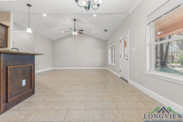 unfurnished living room with baseboards, plenty of natural light, light tile patterned flooring, and vaulted ceiling