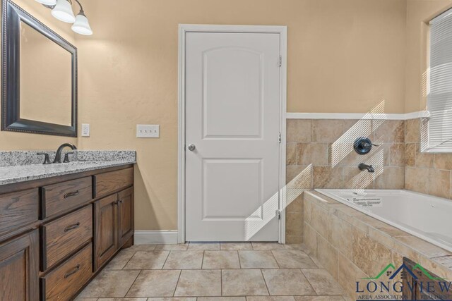 bathroom with vanity, a garden tub, and tile patterned floors