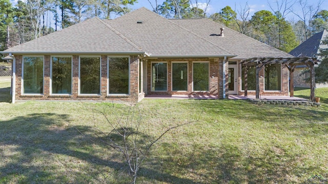 rear view of house featuring a yard and a pergola