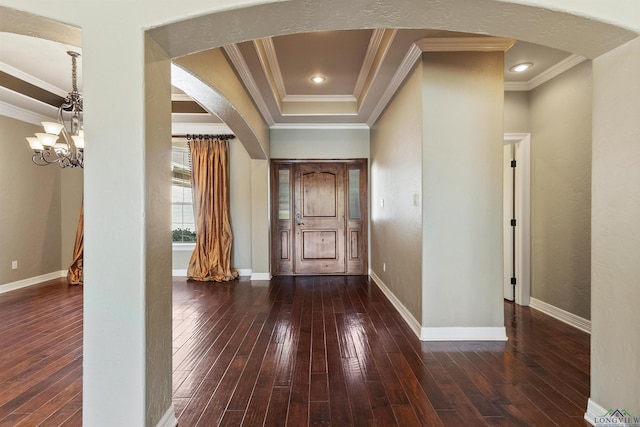 entrance foyer with a chandelier, dark hardwood / wood-style floors, and ornamental molding