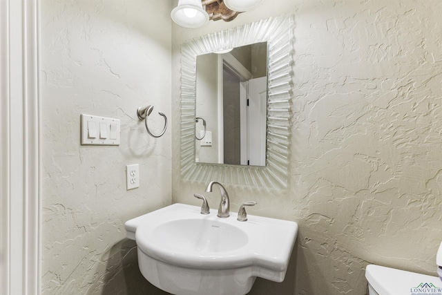 bathroom with toilet and sink