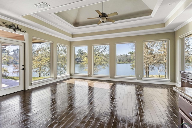 unfurnished sunroom with a raised ceiling, ceiling fan, and a water view