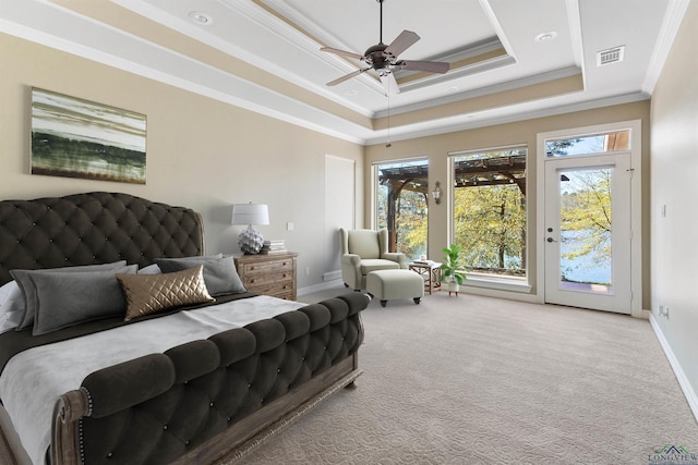 carpeted bedroom featuring access to outside, crown molding, ceiling fan, and a tray ceiling