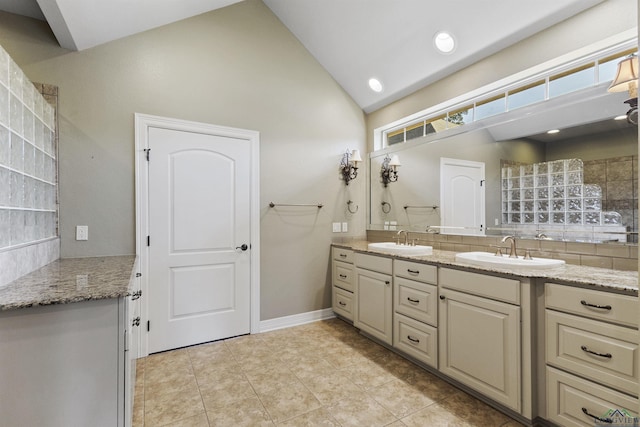 bathroom with tile patterned floors, decorative backsplash, vanity, and high vaulted ceiling