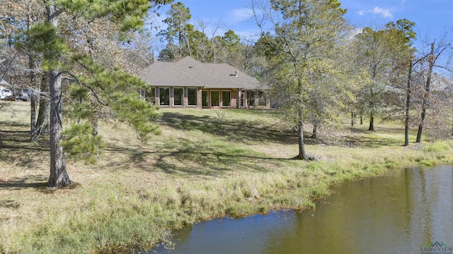 rear view of property with a water view