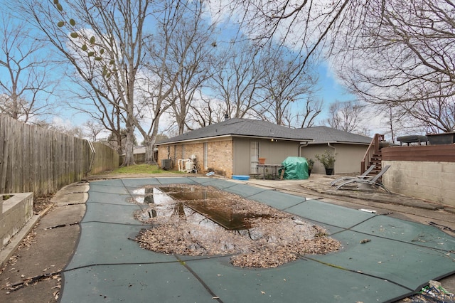 back of house featuring a patio and a covered pool