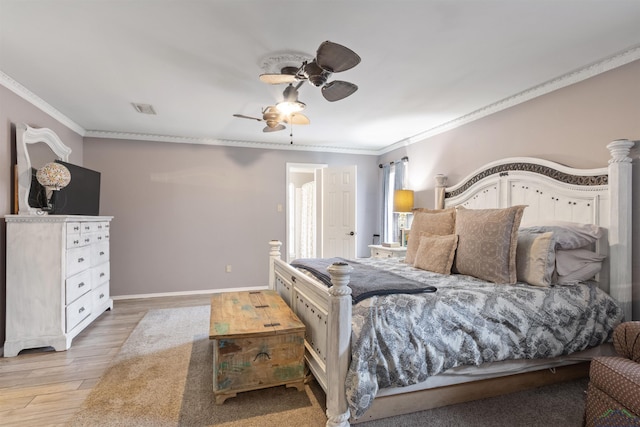 bedroom with hardwood / wood-style floors, ornamental molding, and ceiling fan