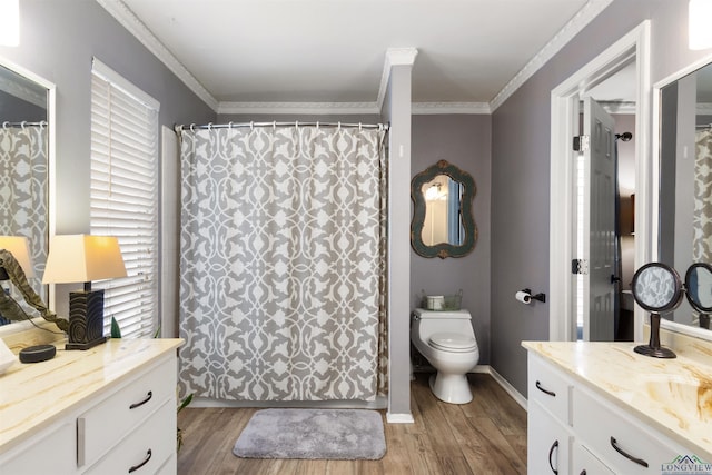 bathroom with ornamental molding, toilet, hardwood / wood-style floors, and vanity