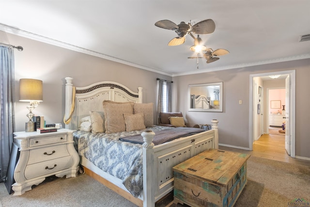 carpeted bedroom featuring ornamental molding and ceiling fan