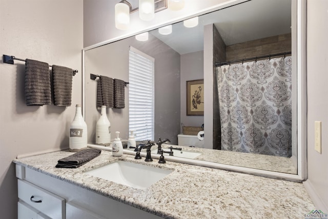 bathroom featuring walk in shower, vanity, and toilet