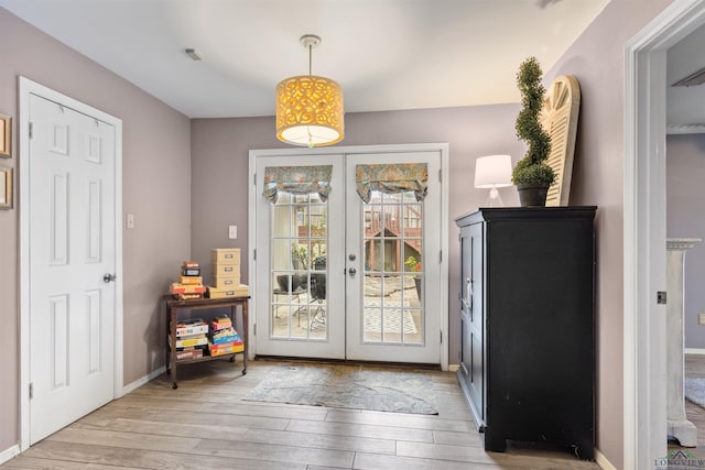 entryway featuring french doors and light hardwood / wood-style flooring