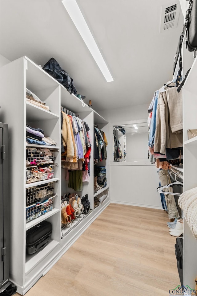 spacious closet featuring light hardwood / wood-style floors