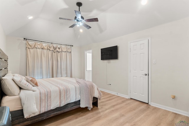 bedroom with vaulted ceiling, light hardwood / wood-style floors, and ceiling fan