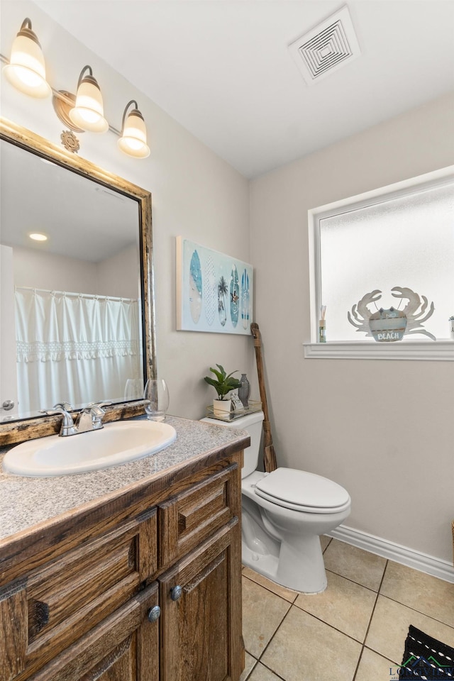 bathroom featuring tile patterned floors, vanity, and toilet