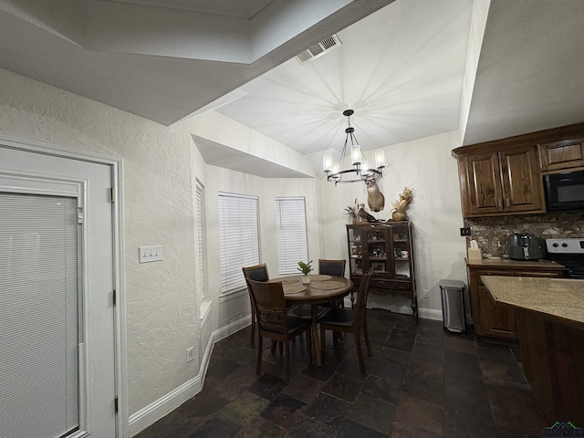 dining space with an inviting chandelier