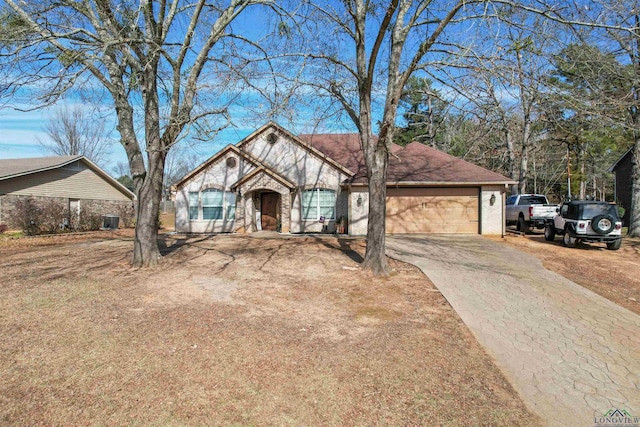 single story home with a garage and central AC