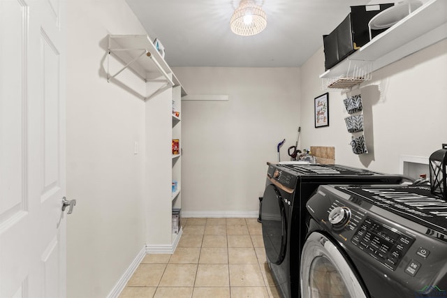 laundry area featuring separate washer and dryer and light tile patterned floors