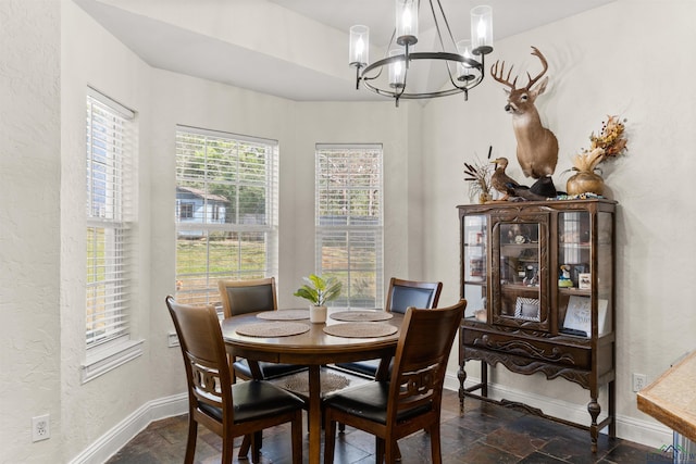 dining area featuring a notable chandelier