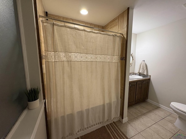 bathroom featuring tile patterned floors, walk in shower, vanity, and toilet