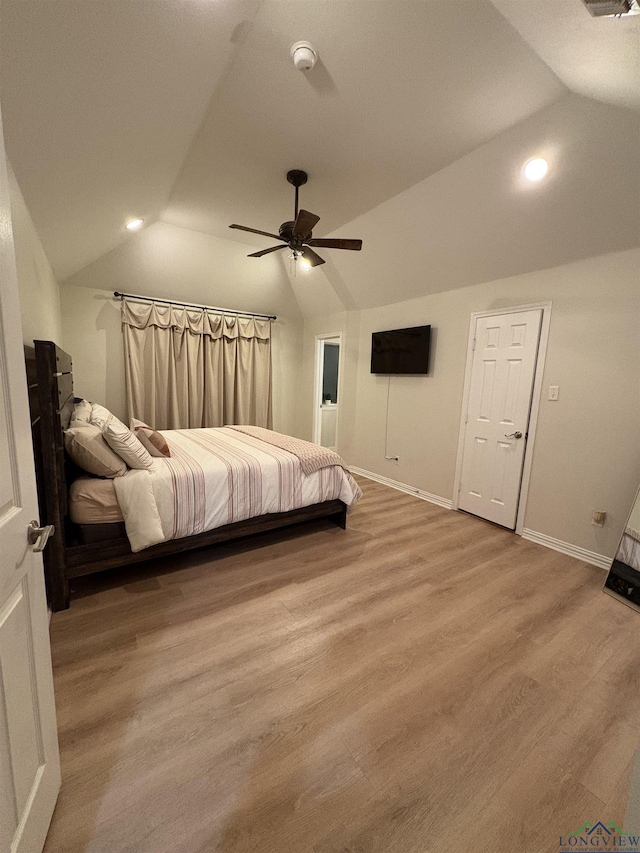 unfurnished bedroom featuring ceiling fan, light hardwood / wood-style floors, and lofted ceiling